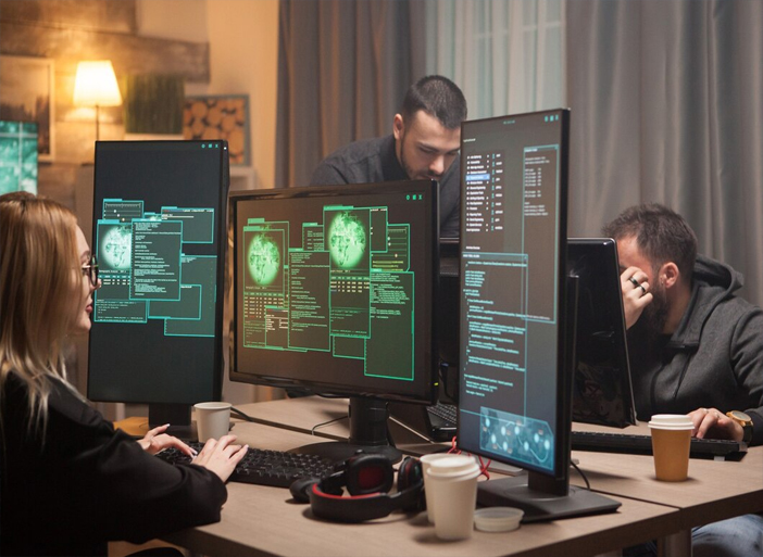 A diverse team collaborating on a digital network, surrounded by protective firewalls and shields, emphasizing the collective effort required for cybersecurity.
